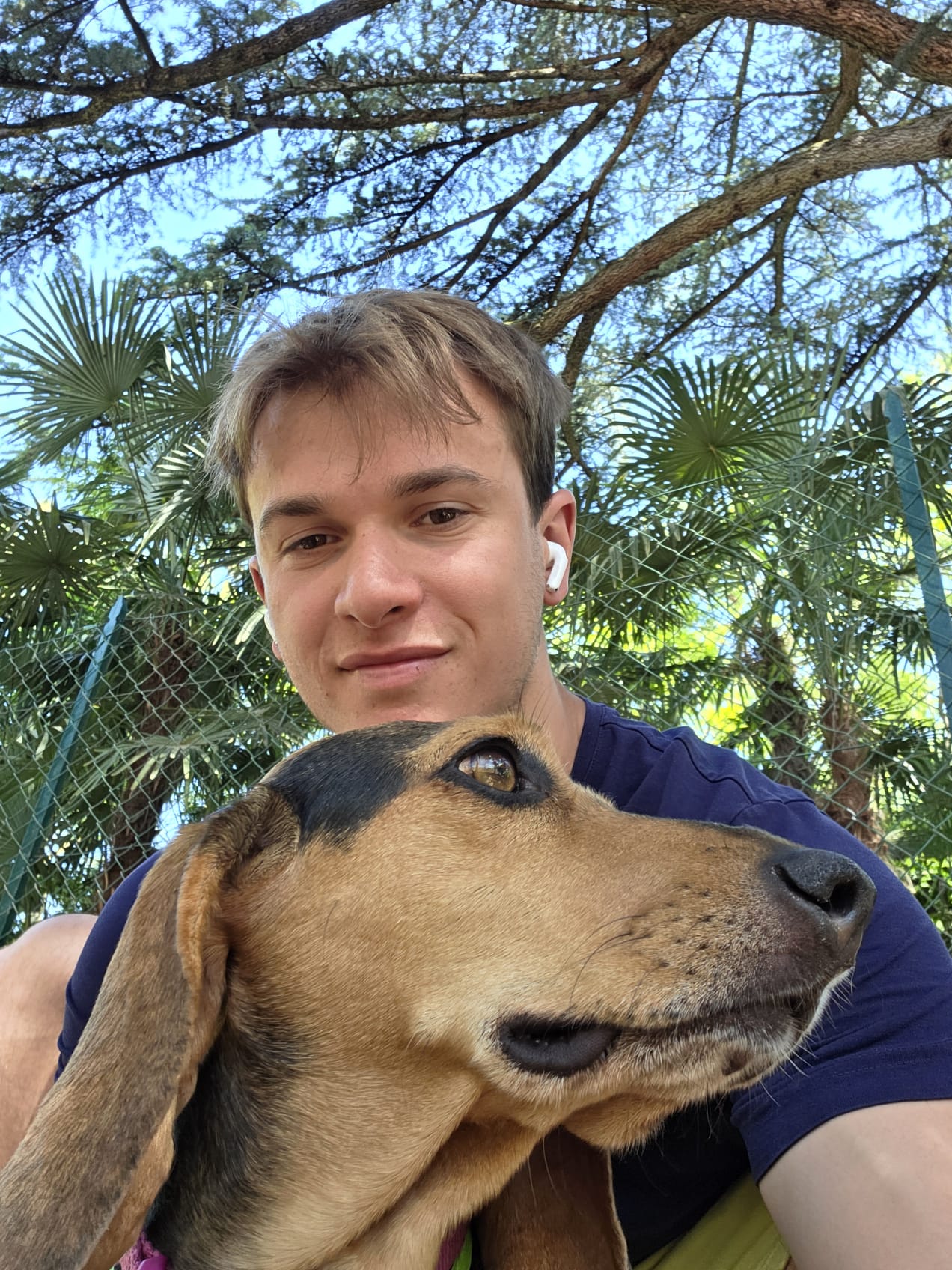 Samuel Longo sitting outdoors with a dog